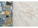 Luxurious shower showcasing blue and gold marble-style tile and black fixtures at 2305 W Kentucky Ave, Tampa, FL 33607