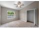 Neutral bedroom with closet, ceiling fan, and bright window overlooking outdoors at 2512 Clubhouse Dr, Plant City, FL 33566