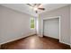 Cozy bedroom featuring wood floors, a ceiling fan, and a closet for ample storage at 2512 Clubhouse Dr, Plant City, FL 33566