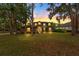 Charming home exterior featuring large windows, a welcoming entrance, and manicured lawn at sunset at 2512 Clubhouse Dr, Plant City, FL 33566