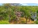 Beautiful home featuring mature trees and a lush green lawn in a serene, wooded setting at 2512 Clubhouse Dr, Plant City, FL 33566