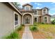 Two-story home boasts mature landscaping and covered entryway, creating inviting curb appeal at 2512 Clubhouse Dr, Plant City, FL 33566