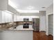 Modern kitchen boasts stainless steel appliances, granite countertops, and ample cabinet space at 2512 Clubhouse Dr, Plant City, FL 33566