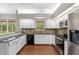 Well-equipped kitchen with sleek stainless steel appliances and bright white cabinets at 2512 Clubhouse Dr, Plant City, FL 33566