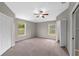 Spacious carpeted main bedroom with two windows and ensuite bathroom and closet entries at 2512 Clubhouse Dr, Plant City, FL 33566