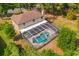 Aerial view of a screened-in pool and lush greenery, offering a private outdoor retreat at 2512 Clubhouse Dr, Plant City, FL 33566