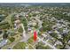 Home's location amid a lush, green neighborhood featuring nearby roads and mature trees at 2961 Stockwood Dr, Clearwater, FL 33761