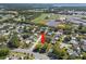 Aerial view of a home nestled in a suburban neighborhood close to a school, baseball fields and highway access at 2961 Stockwood Dr, Clearwater, FL 33761