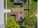 Aerial shot reveals roof, trees, small fenced in back yard and proximity to neighborhood street at 2961 Stockwood Dr, Clearwater, FL 33761