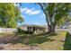 Spacious backyard with well-maintained lawn, mature trees, and a white fence at 2961 Stockwood Dr, Clearwater, FL 33761