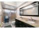 Bathroom featuring a double sink vanity with a granite countertop and a shower over tub at 2961 Stockwood Dr, Clearwater, FL 33761