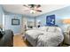 Bedroom features a decorative sign, hardwood floors, ceiling fan, and sliding glass door at 2961 Stockwood Dr, Clearwater, FL 33761