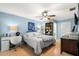 Bedroom with hardwood floors, ceiling fan, desk area and coastal decor at 2961 Stockwood Dr, Clearwater, FL 33761