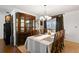 Elegant dining room featuring a large wooden table, hutch and view of the outside through the window at 2961 Stockwood Dr, Clearwater, FL 33761