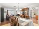 Open dining room featuring a chandelier, hardwood floors and seating for six at 2961 Stockwood Dr, Clearwater, FL 33761