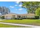 Charming single-story home with a well-manicured lawn, mature trees and a two car garage at 2961 Stockwood Dr, Clearwater, FL 33761
