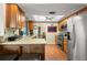 Bright kitchen showcasing a stainless steel fridge, eat-in counter, and wood cabinets at 2961 Stockwood Dr, Clearwater, FL 33761