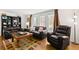 Cozy living room with hardwood floors, leather sofas and an accent rug creating a warm and inviting space at 2961 Stockwood Dr, Clearwater, FL 33761