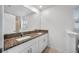 Bathroom featuring double sinks with granite countertops and white cabinets at 30752 Veridian Way, Wesley Chapel, FL 33545
