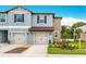 Delightful townhome with a two-car garage, charming curb appeal, and stone accents at 30752 Veridian Way, Wesley Chapel, FL 33545