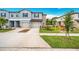 Inviting townhome with a two-car garage, well-manicured lawn, and clear blue sky at 30752 Veridian Way, Wesley Chapel, FL 33545