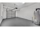 A clean, spacious two-car garage with an epoxy floor and automatic door offers a blank canvas at 30752 Veridian Way, Wesley Chapel, FL 33545