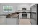 Kitchen with granite countertops, stainless steel appliances, and breakfast bar at 30752 Veridian Way, Wesley Chapel, FL 33545