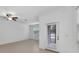 Bright living room with neutral tile flooring and a glass panel back door at 30752 Veridian Way, Wesley Chapel, FL 33545