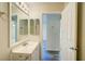 This bathroom has a vanity with a mirror, modern fixtures, and tile flooring at 3206 Shalimar Ter, North Port, FL 34286