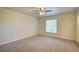 Empty bedroom with carpet flooring, a ceiling fan, and natural light from the window at 3206 Shalimar Ter, North Port, FL 34286