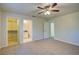 Carpeted bedroom with ceiling fan, ensuite bathroom, and walk-in closet for maximized space and comfort at 3206 Shalimar Ter, North Port, FL 34286