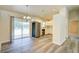 Open-concept dining area with sliding glass doors and modern light fixture, adjacent to the kitchen at 3206 Shalimar Ter, North Port, FL 34286