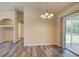 Dining area with sliding glass door and stylish light fixture at 3206 Shalimar Ter, North Port, FL 34286