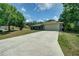 Exterior of home with a large driveway, lush lawn, and a 2 car garage at 3206 Shalimar Ter, North Port, FL 34286