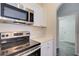 Close up view of kitchen with stainless steel appliances and white countertops at 3206 Shalimar Ter, North Port, FL 34286