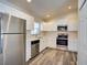 Modern kitchen featuring stainless steel appliances, white cabinets, and durable flooring at 3206 Shalimar Ter, North Port, FL 34286