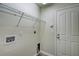 Functional laundry room features white appliances hookups and a door to the outside at 3206 Shalimar Ter, North Port, FL 34286