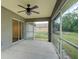 This screened patio has a ceiling fan, sliding glass door access to the house, and a great view of the yard at 3206 Shalimar Ter, North Port, FL 34286