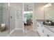 Bright, modern bathroom with a glass shower and elegant fixtures at 3213 Lumber Falls Dr, Plant City, FL 33565