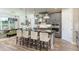 Modern kitchen featuring gray cabinets, an island with barstool seating, and stainless steel appliances at 3213 Lumber Falls Dr, Plant City, FL 33565