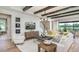 Open-concept living room with modern decor, hardwood floors, and a large window with natural light at 3213 Lumber Falls Dr, Plant City, FL 33565