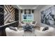 Stylish seating area with custom wall accent, modern lighting, and elegant decor at 3213 Lumber Falls Dr, Plant City, FL 33565