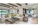 Spacious living room with stylish furnishings, modern lighting, and views of the pond at 3213 Lumber Falls Dr, Plant City, FL 33565