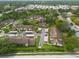 An aerial view showing the arrangement of townhouses with covered parking spaces and surrounding green spaces at 3540 Countrybrook Ln # 23, Palm Harbor, FL 34684