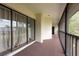 Spacious balcony features neutral carpeting, railing, and large sliding glass doors at 3540 Countrybrook Ln # 23, Palm Harbor, FL 34684