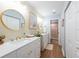 Modern bathroom with dual vanities, gold fixtures, and large mirrors at 3540 Countrybrook Ln # 23, Palm Harbor, FL 34684