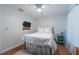 Comfortable bedroom featuring a gold-framed bed, ceiling fan, and hardwood floors at 3540 Countrybrook Ln # 23, Palm Harbor, FL 34684