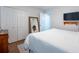 Bright bedroom with a full-length mirror and modern television at 3540 Countrybrook Ln # 23, Palm Harbor, FL 34684