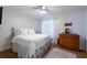 Cozy bedroom with white walls, ceiling fan, and hardwood floors at 3540 Countrybrook Ln # 23, Palm Harbor, FL 34684