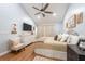 Cozy bedroom with soft color palette, ceiling fan, luxury bed and wood laminate flooring at 3540 Countrybrook Ln # 23, Palm Harbor, FL 34684